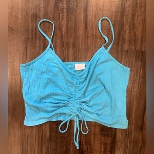 Blue cropped tank top with ruching and tie-front